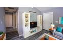 Mud room featuring a seating area with a bookcase, gray walls, and wood-look floors at 4373 Atwater Dr, North Port, FL 34288