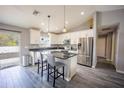 Modern kitchen featuring stainless steel appliances, granite countertops, a stylish island, and luxury vinyl plank flooring at 4373 Atwater Dr, North Port, FL 34288