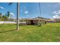 Rear view of this well-maintained home with an expansive, fully fenced green backyard at 760 Devon Rd, Venice, FL 34293