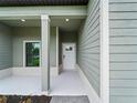 Inviting front porch with modern support columns and a stylish front door at 12156 Wellington Ave, Port Charlotte, FL 33981