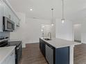 Beautiful kitchen with stainless steel appliances, pendant lighting, and a spacious island at 12156 Wellington Ave, Port Charlotte, FL 33981