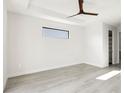 Bright, airy bedroom with wood-look flooring and a modern ceiling fan at 14319 Allensworth Ave, Port Charlotte, FL 33981