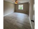 Bright bedroom featuring new laminate flooring and a large window offering natural light at 1517 Abel St, Port Charlotte, FL 33952