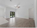 Bright living room with tile floors, ceiling fan, and sliding glass doors leading to the backyard at 17339 Elmwood Ave, Port Charlotte, FL 33948