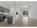 Open-concept living space with modern kitchen island, sleek cabinets, and contemporary finishes at 17339 Elmwood Ave, Port Charlotte, FL 33948
