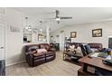 Cozy living room with hardwood floors, vaulted ceilings and comfortable seating; open to the updated kitchen at 209 Seminole Nw Blvd, Port Charlotte, FL 33952