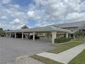 Convenient covered parking area with ample space for residents and visitors, nestled within a landscaped setting at 220 Coldeway Dr # 123, Punta Gorda, FL 33950
