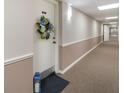Hallway leading to Unit 312, featuring a wreath on the door, and lantern on the floor at 2290 Aaron St # 312, Port Charlotte, FL 33952