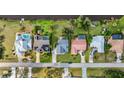 Aerial view of a row of homes, some with pools and solar panels, along a waterfront at 23240 Fullerton Ave, Punta Gorda, FL 33980