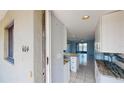 Inviting condo entrance leading to an open-concept living space with tiled floors and access to the screened lanai at 25225 Rampart Blvd # 604, Punta Gorda, FL 33983
