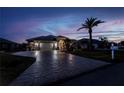 Well-maintained house featuring a paved driveway, manicured lawn and landscaped garden at 26089 Templar Ln, Punta Gorda, FL 33983