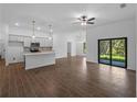 Open living space with modern kitchen, tile floors, and sliding doors leading to the backyard creates a seamless indoor-outdoor flow at 368 Manly St, Port Charlotte, FL 33953
