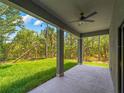 Covered patio with a ceiling fan provides a perfect outdoor living space with views of the grassy backyard at 368 Manly St, Port Charlotte, FL 33953
