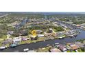 Aerial view of neighborhood showcasing home's waterfront location along a canal with access to a larger body of water at 4091 Rock Creek Dr, Port Charlotte, FL 33948