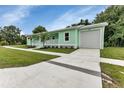 Exterior of mint home with an attached garage and a long driveway at 535 Milus St, Punta Gorda, FL 33950