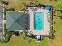 Aerial view of pool with lounge chairs and well-maintained landscaping at 601 Shreve St # 62A, Punta Gorda, FL 33950