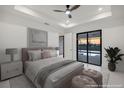 Serene main bedroom with a king-sized bed, soft lighting, and access to the pool area at 9493 St Paul Dr, Port Charlotte, FL 33981