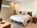 Cozy bedroom featuring a bed with leaf pattern bedding, two side tables and modern decor at 1315 Santiago Ct, Punta Gorda, FL 33950