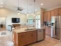 Spacious kitchen featuring stainless steel appliances, a large island with a sink, and an open view to the living area at 1315 Santiago Ct, Punta Gorda, FL 33950