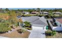 Aerial view of home highlighting lush landscaping, and a spacious driveway for parking at 13632 Clara Ln, Port Charlotte, FL 33981
