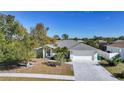 Beautiful home with manicured front yard, a two-car garage, and serene landscaping at 13632 Clara Ln, Port Charlotte, FL 33981