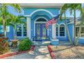 Inviting front entrance with white columns and a decorative American flag, creating a warm welcome at 1563 Arundel Ave, North Port, FL 34288