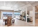 Open-concept living room with a ceiling fan, tile floors, and large windows with water views at 168 Morgan Se Ln, Port Charlotte, FL 33952