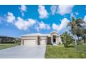 Beautiful home with a well-manicured lawn and three-car garage at 17261 Naiad Ct, Punta Gorda, FL 33955