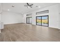 Spacious living room with expansive windows offering abundant natural light and wood flooring at 17261 Naiad Ct, Punta Gorda, FL 33955