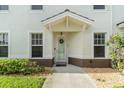 Charming townhouse entrance featuring a welcoming covered porch and well-maintained landscaping at 17288 Acapulco Rd # 411, Punta Gorda, FL 33955