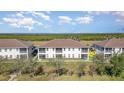 Beautiful back exterior of townhouse with screened lanai, offering stunning water views and privacy at 17288 Acapulco Rd # 411, Punta Gorda, FL 33955