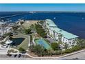 Aerial view of condominium featuring a community park, tennis courts, and water access at 200 Harbor Walk Dr # 221, Punta Gorda, FL 33950