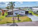 Cozy single-Gathering home with a well-kept lawn, complemented by mature palm trees and a convenient driveway at 215 Schooner St, North Port, FL 34287