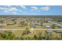Expansive aerial view showcasing the property within a peaceful residential neighborhood surrounded by lush greenery at 25413 Prada Dr, Punta Gorda, FL 33955