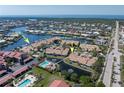 Real estate aerial view featuring community, waterway, neighboring houses, and overall surrounding area at 2645 W Marion Ave # 114, Punta Gorda, FL 33950