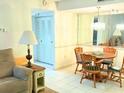Open layout view of dining area with table, chandelier, and access to the living room at 3006 Caring Way # 329, Port Charlotte, FL 33952