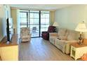 Bright living room with sliding glass doors and comfortable seating arrangement at 3006 Caring Way # 329, Port Charlotte, FL 33952