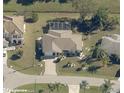 Aerial view of a home with a well-maintained lawn and an attached two-car garage at 32 Bariloche Dr, Punta Gorda, FL 33983