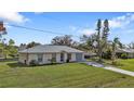 Well-kept single-story home with green lawn and driveway at 3436 Discovery Dr, Punta Gorda, FL 33983