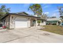 Home featuring a garage and nice lawn, offering great curb appeal in a residential setting at 3956 Fairchild Ave, North Port, FL 34287
