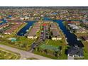 Aerial view of a condo community surrounded by canals, featuring community tennis courts at 4000 Bal Harbor Blvd # 217, Punta Gorda, FL 33950