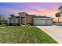 Well maintained single-story home with three-car garage and lush green lawn at 4450 Northshore Dr, Punta Gorda, FL 33980