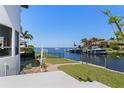 Backyard area with a patio, grass area, and access to a private boat dock and canal at 8 Ocean Dr, Punta Gorda, FL 33950