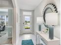 Bright and airy entryway with tile floors, modern decor, a front door with view to the front yard at 12141 Karney Ave, Port Charlotte, FL 33981