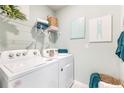 Convenient laundry room with a washer, dryer, and storage shelves, ready for efficient chores at 12141 Karney Ave, Port Charlotte, FL 33981