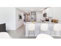 Modern kitchen with stainless steel appliances, a breakfast bar, and open access to other areas at 12149 Karney Ave, Port Charlotte, FL 33981