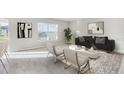 Inviting living room featuring neutral colors, modern decor, and ample natural light from the large window at 12149 Karney Ave, Port Charlotte, FL 33981