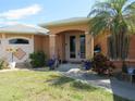 Well-manicured lawn leads to the front entrance of this charming single-story home at 1500 Westover St, Port Charlotte, FL 33953