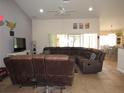 Spacious living room featuring tile flooring, a comfortable sectional sofa, and plenty of natural light at 1500 Westover St, Port Charlotte, FL 33953