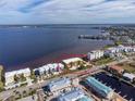 Aerial view showcasing the condo building's prime waterfront location near the bay and bridge, with water views at 1601 Park Beach Cir # 114/4, Punta Gorda, FL 33950